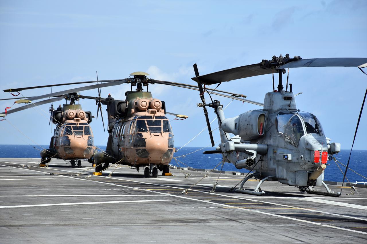 2x AS532 Cougar helicopters and 1x AH-1W helicopter are stationed on deck of the TCG Anadolu ship within the Anadolu Task Force during "Neptune Strike 25.3," Sept. 24, 2025. (AA Photo)