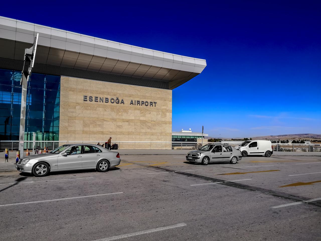 Photo shows cars drive along the road past a building with a signboard Esenboga Airport in Ankara, Türkiye, accessed on Dec. 14, 2025. (Adobe Stock Photo)