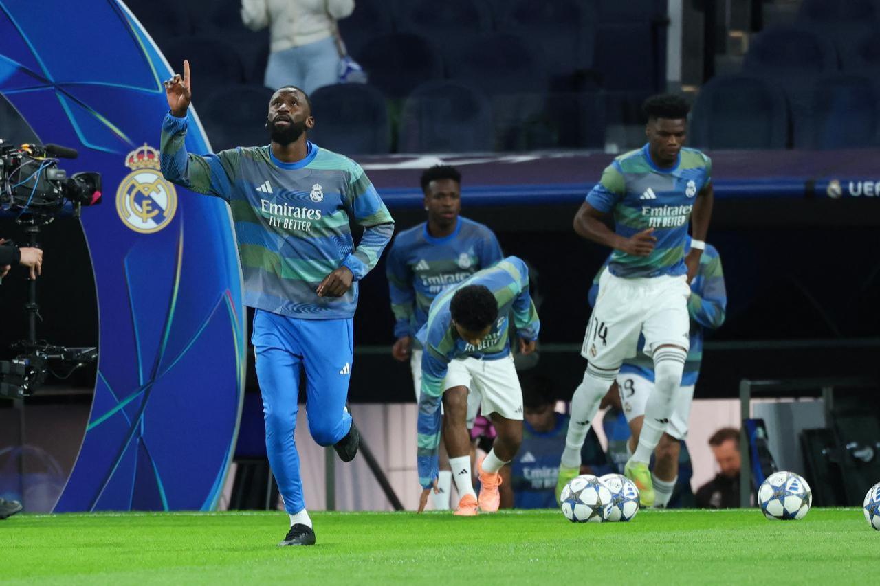 German defender #02 Antonio Rudiger (L), Real Madrid's Brazilian forward #07 Vinicius Junior, and Real Madrid's French midfielder #14 Aurelien Tchouameni (R) enter the pitch for the warmup before the UEFA Champions League match against Manchester City at Santiago Bernabeu Stadium in Madrid, December 10, 2025. (AFP Photo)