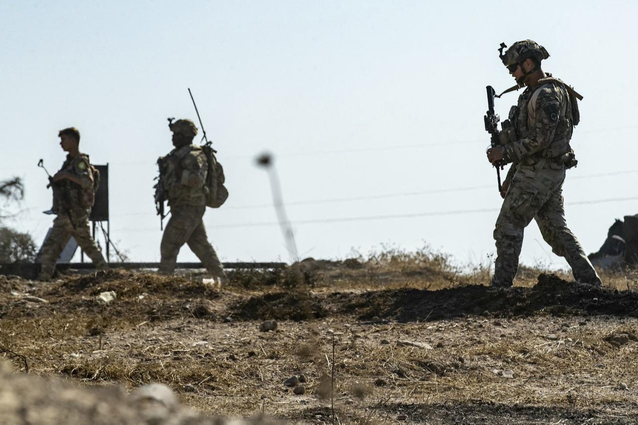 US soldiers inspect the site of reported Turkish shelling days earlier on an oil extraction facility on Oct. 28, 2024. (AFP Photo)
