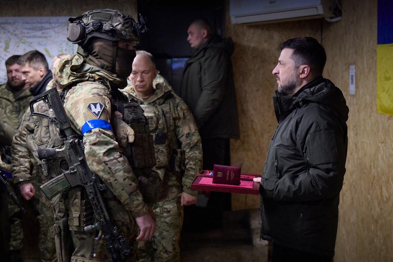 Ukraine's President Volodymyr Zelenskyy (R) gives an award to a Ukrainian soldier in Kupiansk, Kharkiv region, Dec. 12, 2025. (Photo by Handout/Ukrainian Presidential Press Service/AFP)