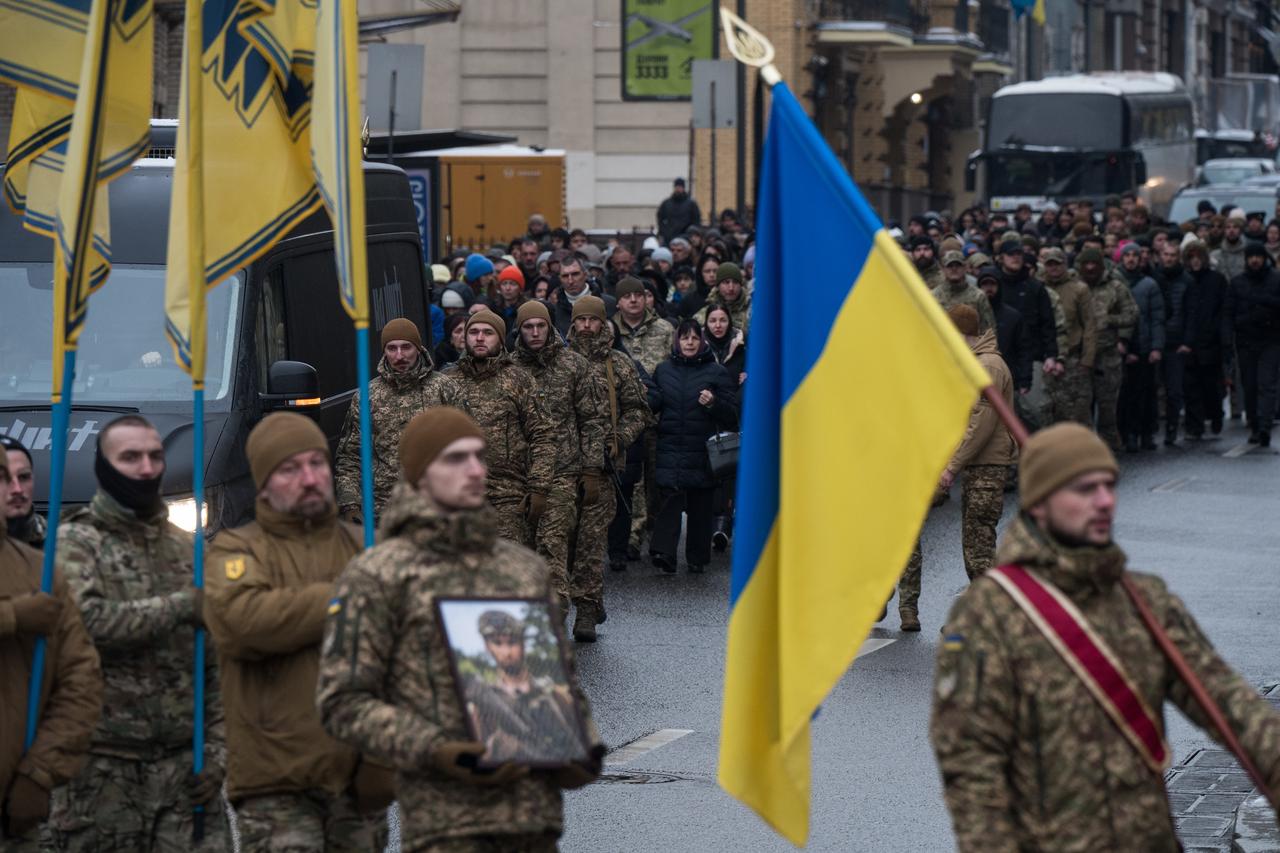 Kyiv residents attend a farewell ceremony for Dmytro Ostrovskyi, a sniper of the Azov Regiment who joined the Armed Forces of Ukraine in 2023 at the age of 18, in Kyiv, Ukraine, on Dec. 14, 2025. (AA Photo)