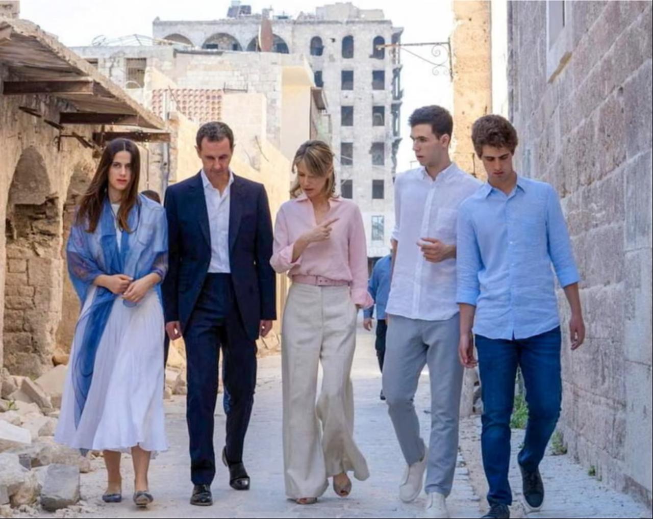 Bashar al-Assad with his wife, Asma, walking with their children in the northern Syrian city of Aleppo in 2022.  ( AFP Photo )