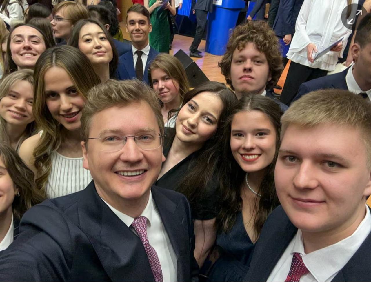 Zein al-Assad, in white dress, on graduating from university ( Photo via  The Guardian )