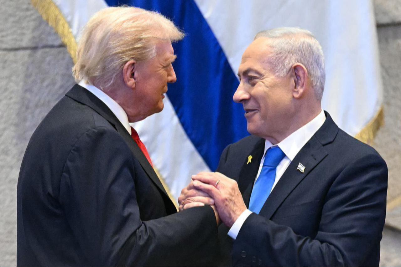 U.S. President Donald Trump (L) holds hands and speaks with Israeli Prime Minister Benjamin Netanyahu at the Israeli parliament, the Knesset, in Jerusalem, Israel on Oct. 13, 2025. (AFP Photo)