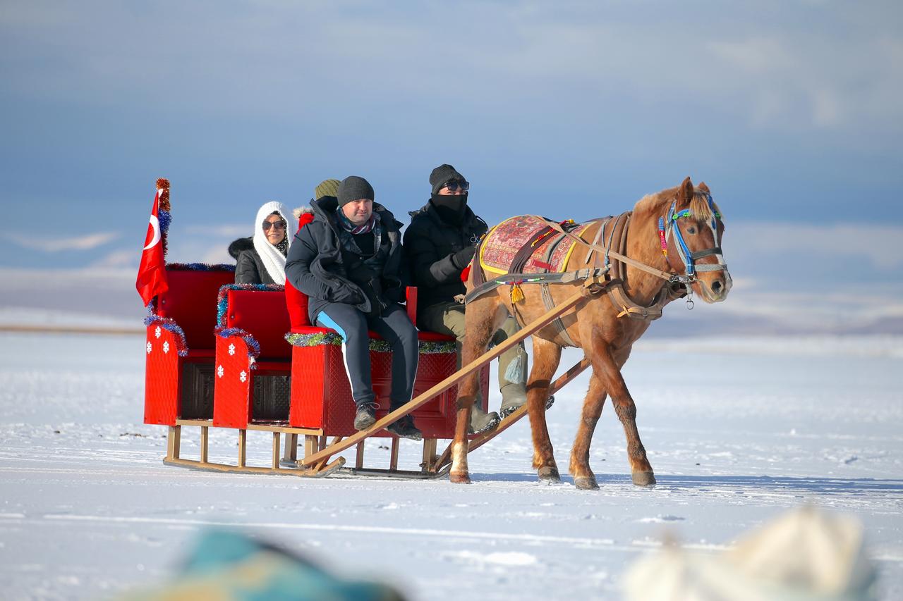 Horse drawn sleigh rides on partially frozen Lake Cildir