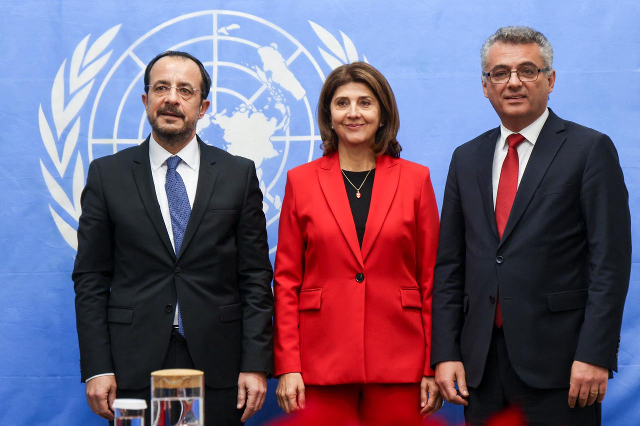 Cyprus' President Nikos Christodoulides, (L) and Turkish Cypriot leader Tufan Erhurman (R) meet with Personal Envoy of the United Nations Secretary-General on Cyprus Maria Angela Holguin in UN buffer zone in Nicosia, Cyprus on Dec. 11, 2025. (AFP Photo)
