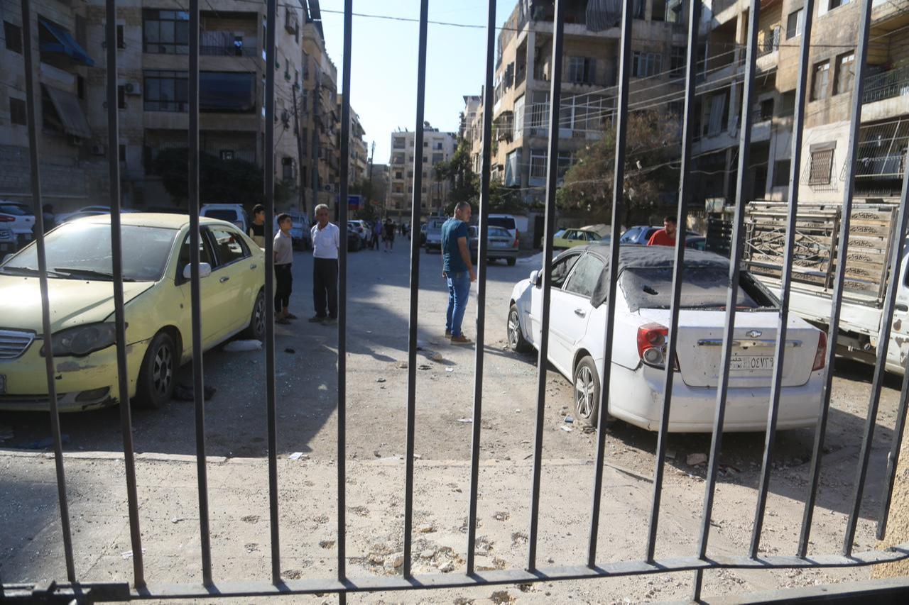 Syrians inspect cars damaged during the clashes between terrorist organization PKK/YPG, which operating under the name SDF and Syrian security forces after ceasefire agreement in Aleppo, Syria, Oct. 7, 2025. (AA Photo)