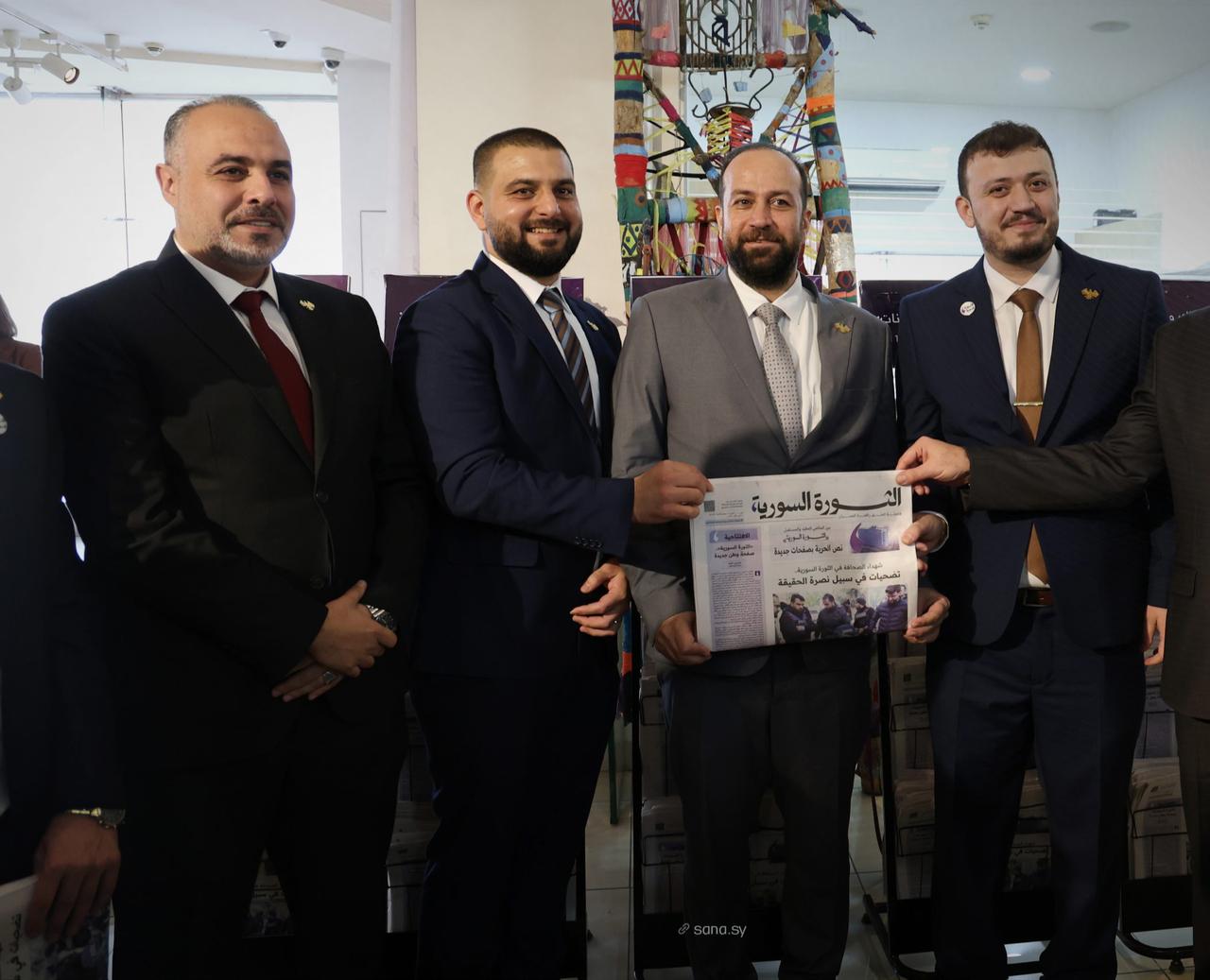 Syrian officials attend the launch ceremony of the new edition of the Al-Thawra al-Suriyya newspaper in Damascus, where its new identity as a print, digital and interactive platform was unveiled, on Dec. 2, 2025. (Photo via SANA)