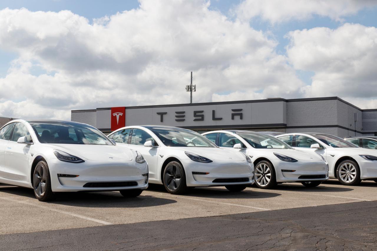 Tesla electric vehicles, including the Model 3, S, and X, are parked outside a dealership in the United States. (Adobe Stock Photo)