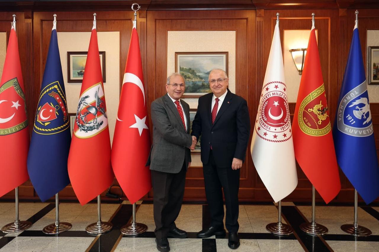 The photo shows Turkish Defense Minister Yasar Guler shaking hands with Akif Bulbul, the Ankara representative of Türkiye daily, at the Defense Ministry's HQ in Ankara, Türkiye on December 19, 2025. (Newsroom Photo)