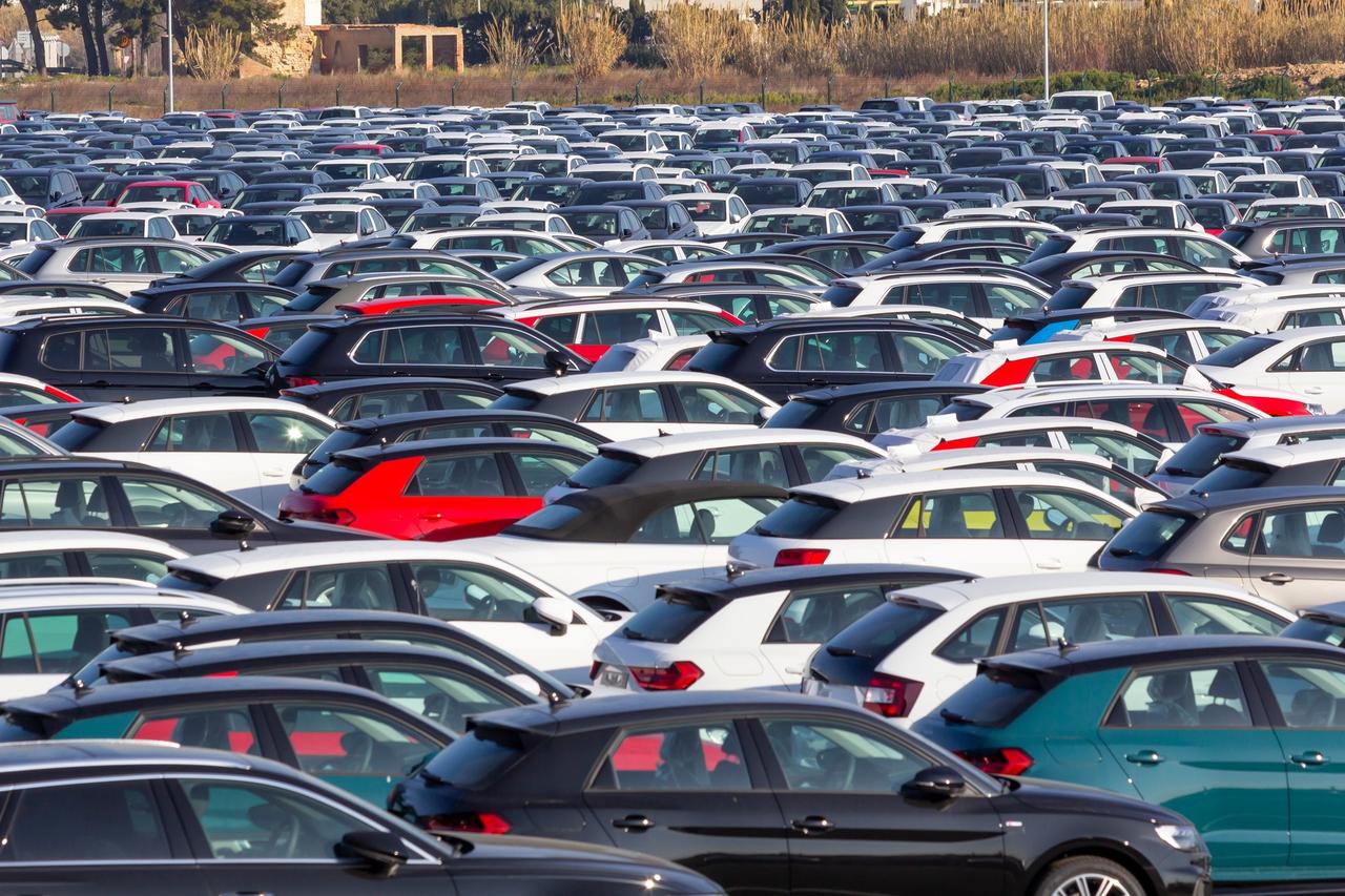 File photo shows of imported vehicles await distribution at a shipping terminal. (Adobe Stock Photo)