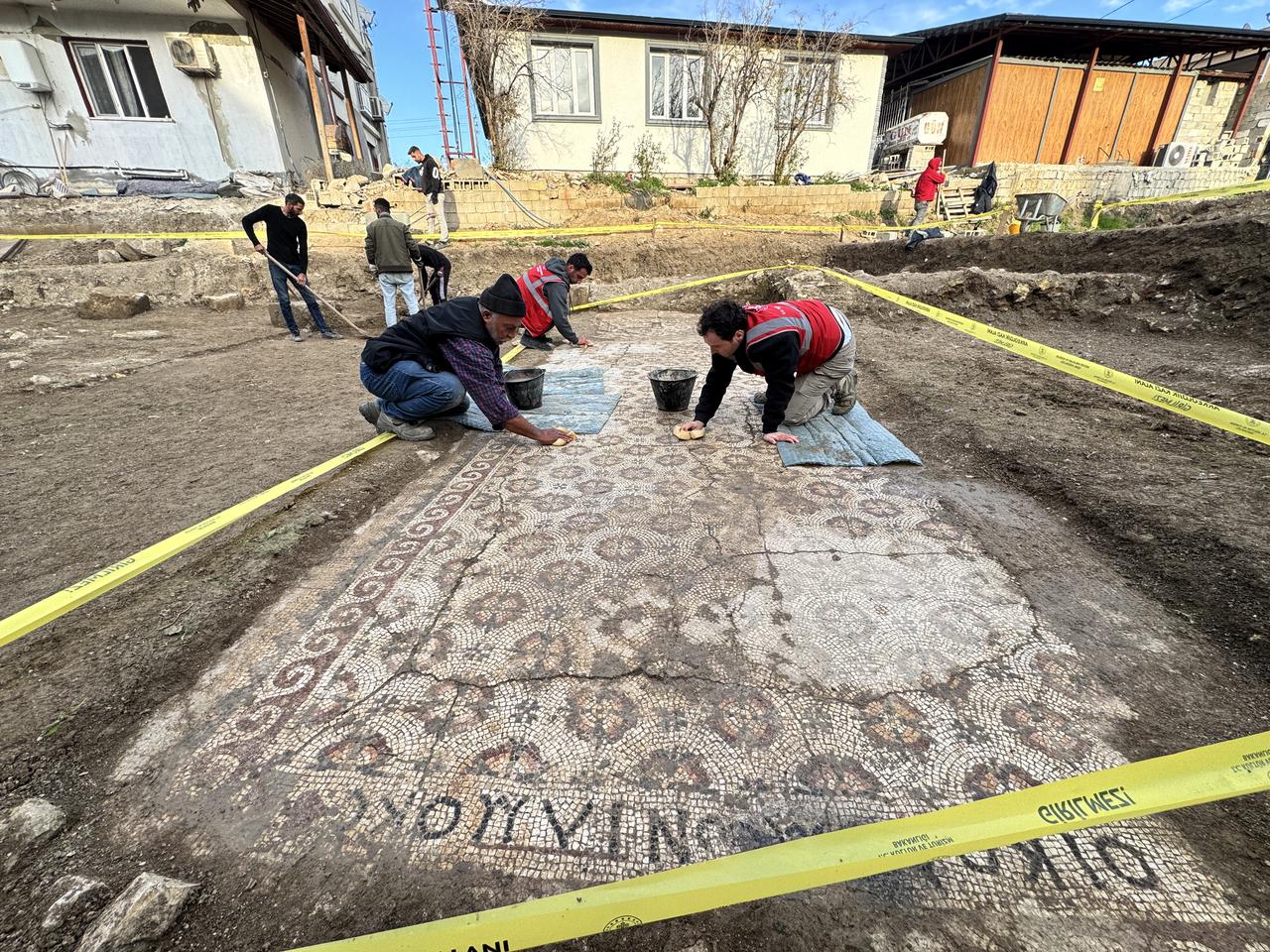 Archeologists and workers are working at the recently discovered 17.5-meter Late Antique floor mosaic featuring Greek inscriptions and geometric patterns in Hatay, Türkiye, Dec. 21, 2025. (AA Photo)