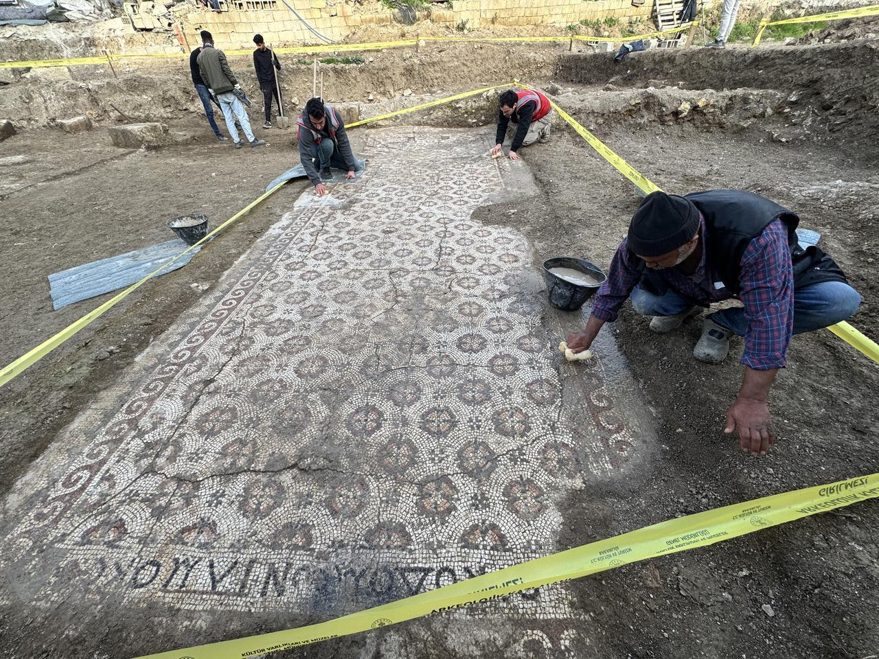 Archeologists and workers are working at the recently discovered 17.5-meter Late Antique floor mosaic featuring Greek inscriptions and geometric patterns in Hatay, Türkiye, Dec. 21, 2025. (AA Photo)
