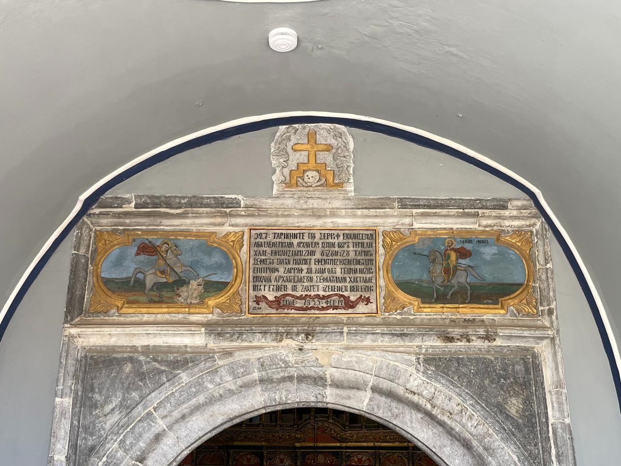 The marble inscription above the entrance of Aya Elenia Church is written in Turkish using Greek letters, a rare example of Karamanli script dating to the 19th-century restoration, Sille, Konya, Türkiye, Dec. 17, 2025. (Photo by Koray Erdogan/Türkiye Today)