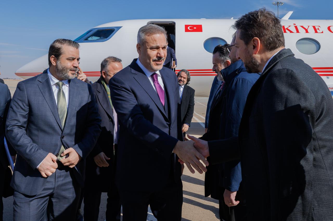 Turkish Foreign Minister Hakan Fidan (C) is welcomed by his Syrian counterpart Asaad Hassan al-Shaibani (L) at Damascus International Airport in Syria, Dec. 22, 2025. (AA Photo)