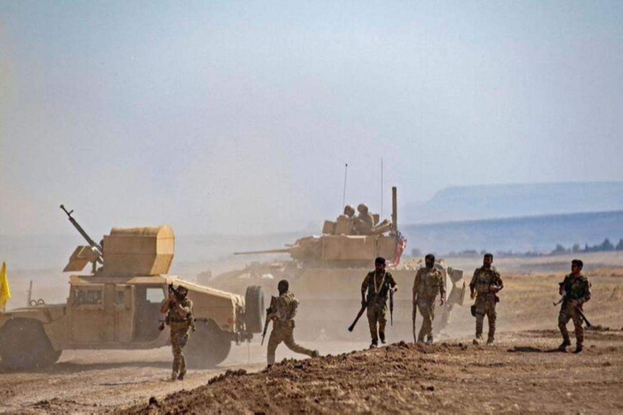 Terrorist organization YPG-led SDF members gather near a US Bradley Fighting Vehicle (BFV) during a joint military exercise in Syrias northeastern al-Hasakah, Sept. 7, 2022. (AFP Photo)