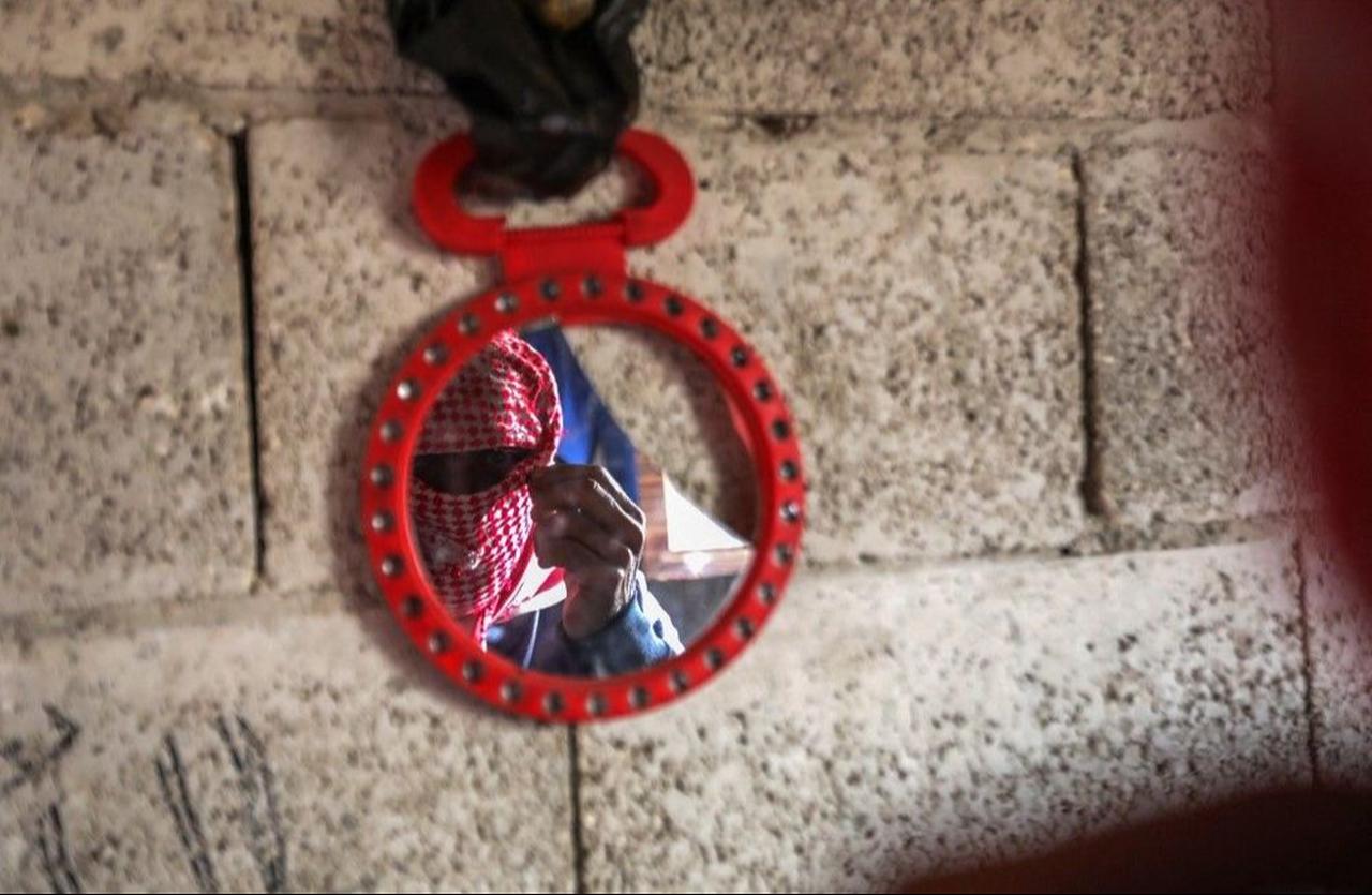 A Captagon dealer masks his face with a traditional keffiyeh scarf before sitting for an interview in the northern Syrian city of Aleppo on April 26, 2022. ( AFP Photo )