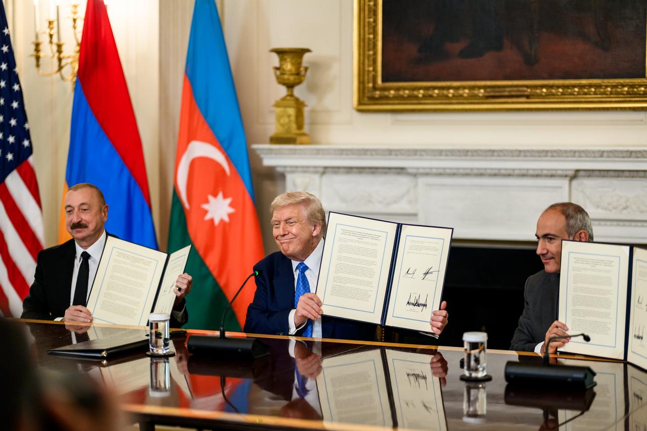 President Donald Trump signs a trilateral joint declaration with President Ilham Aliyev of Azerbaijan and Prime Minister Nikol Pashinyan of Armenia, Friday, August 8, 2025, in the State Dining Room. (Photo via White House)