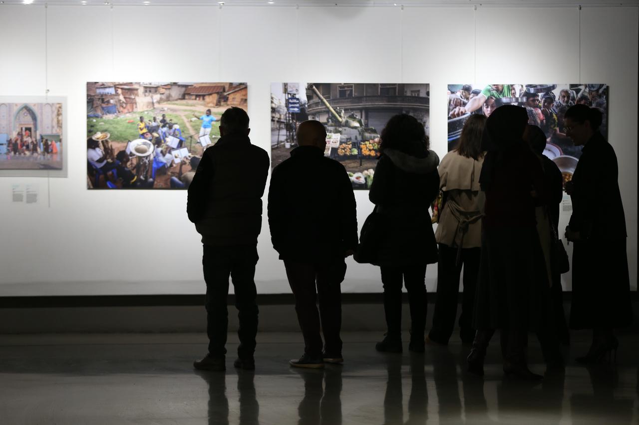 Visitors takes photos of award-winning images on display during the fifth Istanbul Photo Awards 2025 exhibition at the Ofis Art Center in Sakarya, northwestern Türkiye, Dec. 23, 2025. (AA Photo)