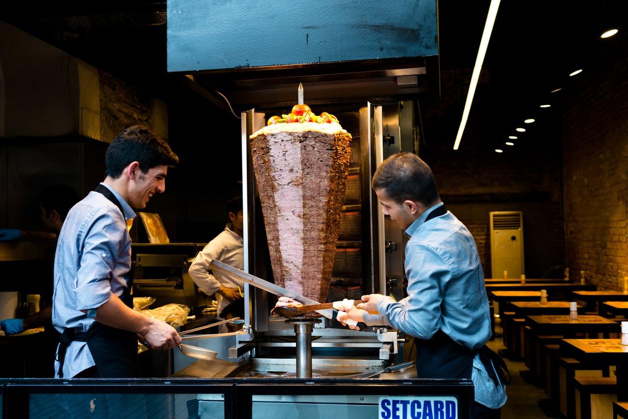 Two men are seen preparing doner kebab at a restaurant on the streets of Istanbul, Türkiye, June 4, 2015. (Adobe Stock Photo)