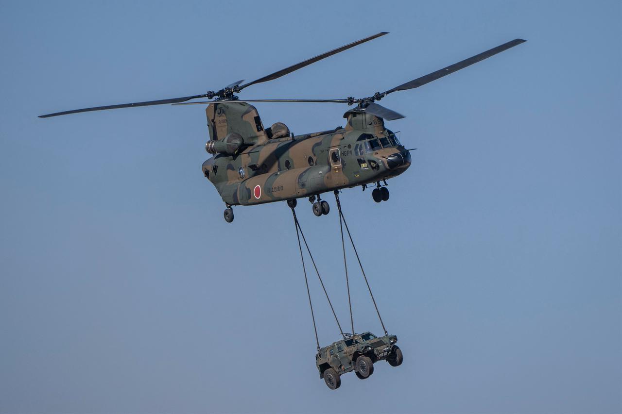 Japan's Ground Self-Defence Force CH-47 helicopter carries a Light Armoured Vehicle(LAV) during a joint military drill in Funabashi, Chiba prefecture, Jan. 8, 2023. (AFP Photo)