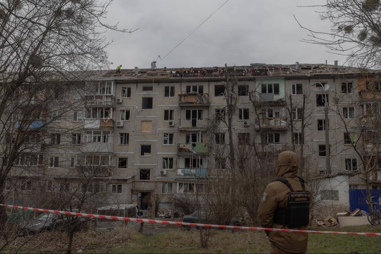 Workers clear debris from the roof of a heavily damaged residential building following a drone strike in Kyiv, Dec. 23, 2025. (AFP Photo)