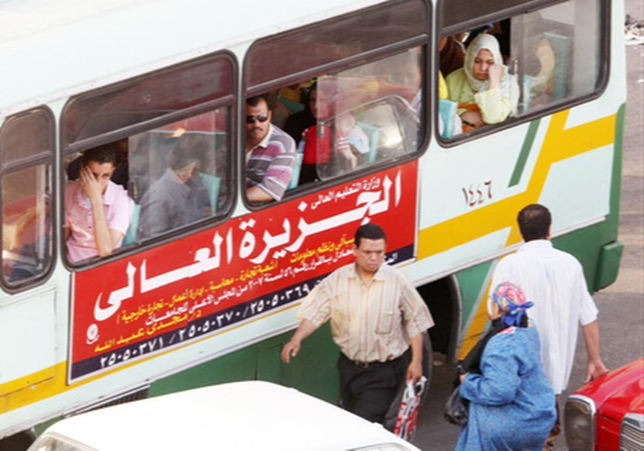 Egyptians ride a public transport bus in Cairo’s populous Attaba district on 9 June 2008. (AFP Photo)