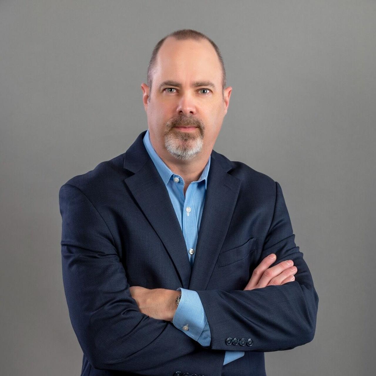 The person in the image is Tim Carpenter, a retired FBI supervisory special agent.