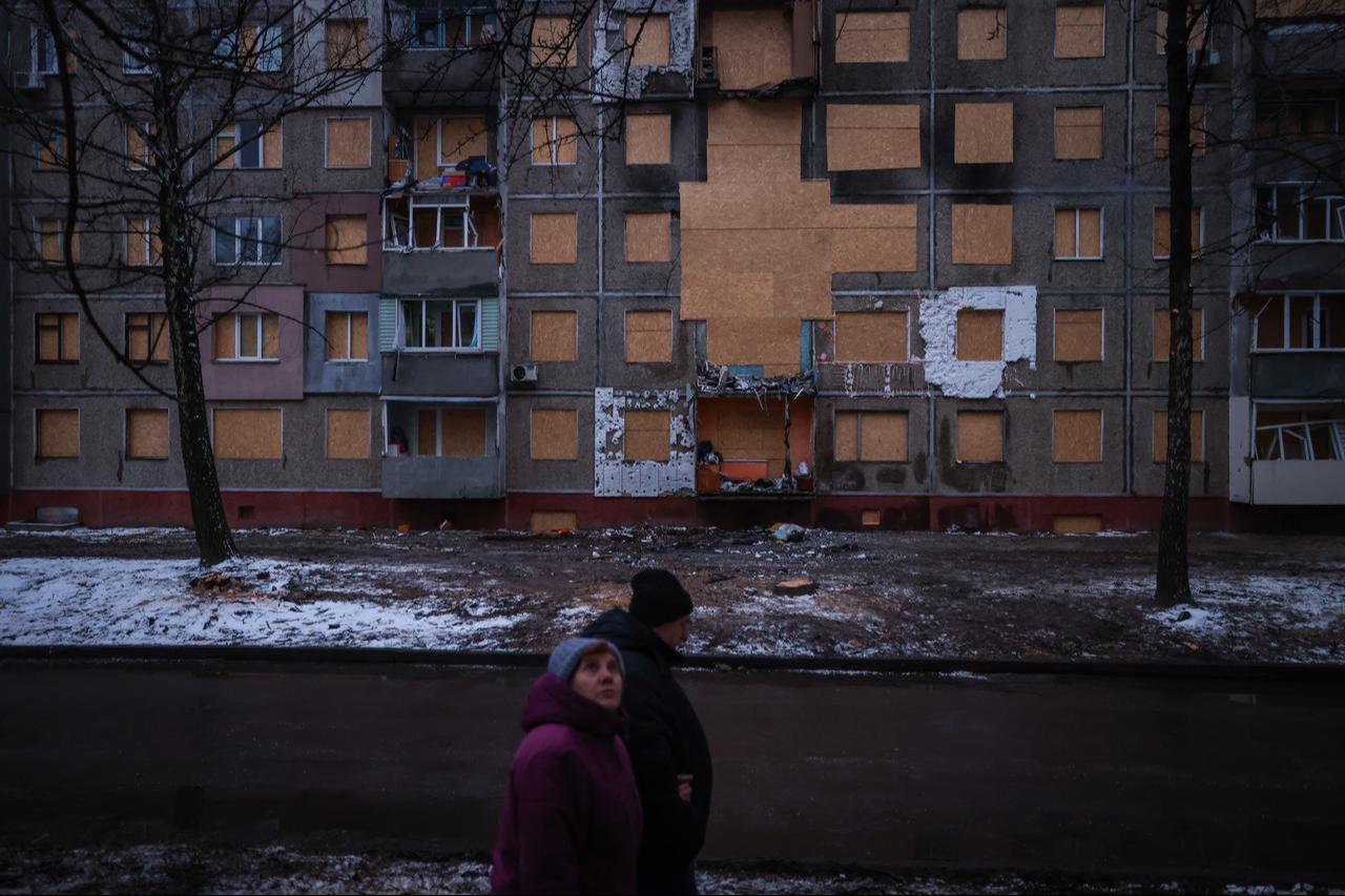 Ukrainian crews board up shattered windows of a damaged five-story residential building following a Russian Shahed-type drone strike in Chernihiv, Ukraine, Dec. 26, 2025. (AA Photo)