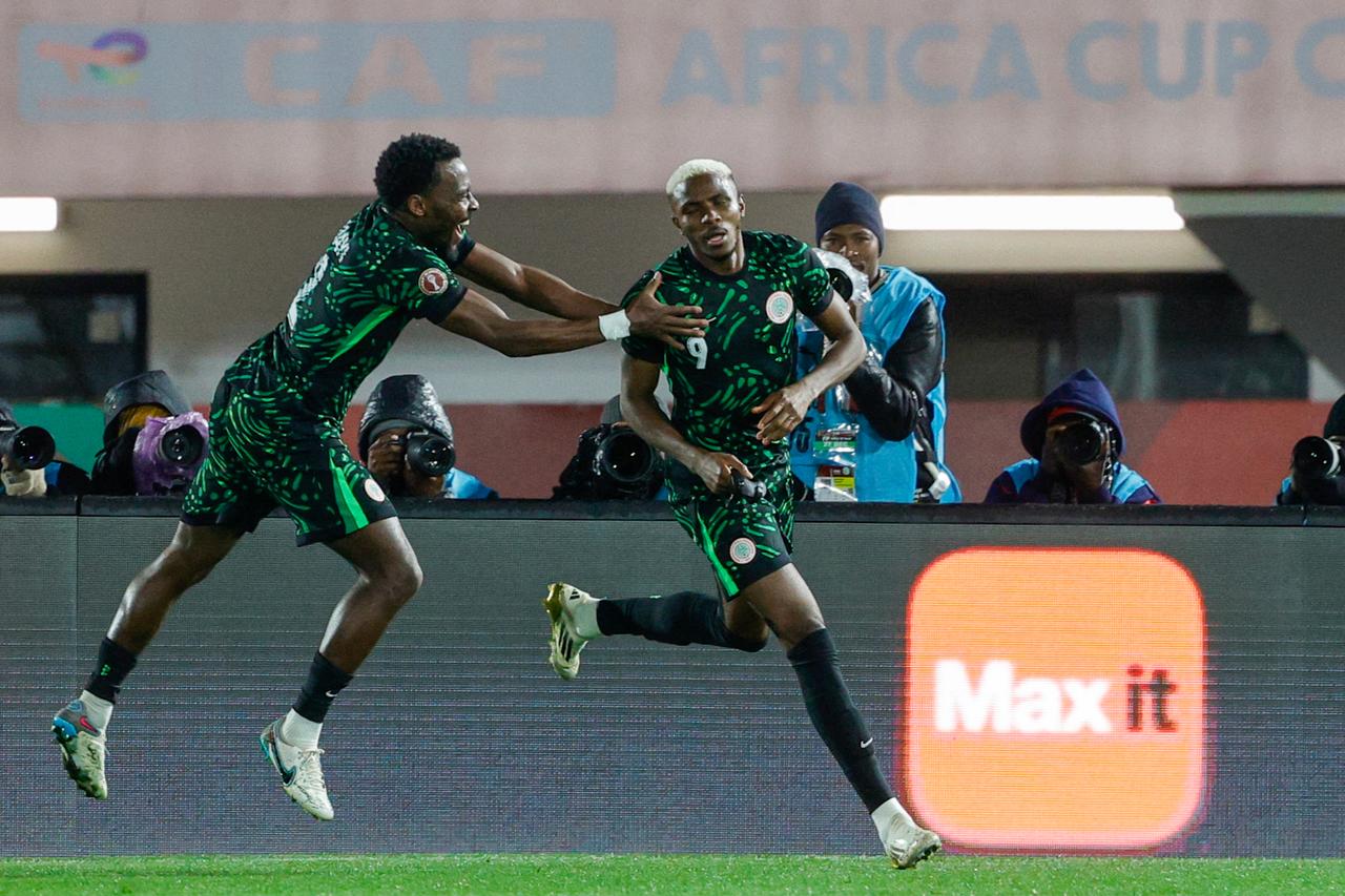 Nigeria's forward #09 Victor Osimhen (R) celebrates his goal with Nigeria's defender #02 Bright Osayi-Samuel during the Africa Cup of Nations (CAN) Group C football match between Nigeria and Tunisia at Fez Stadium in Fez, December 27, 2025. (AFP Photo)