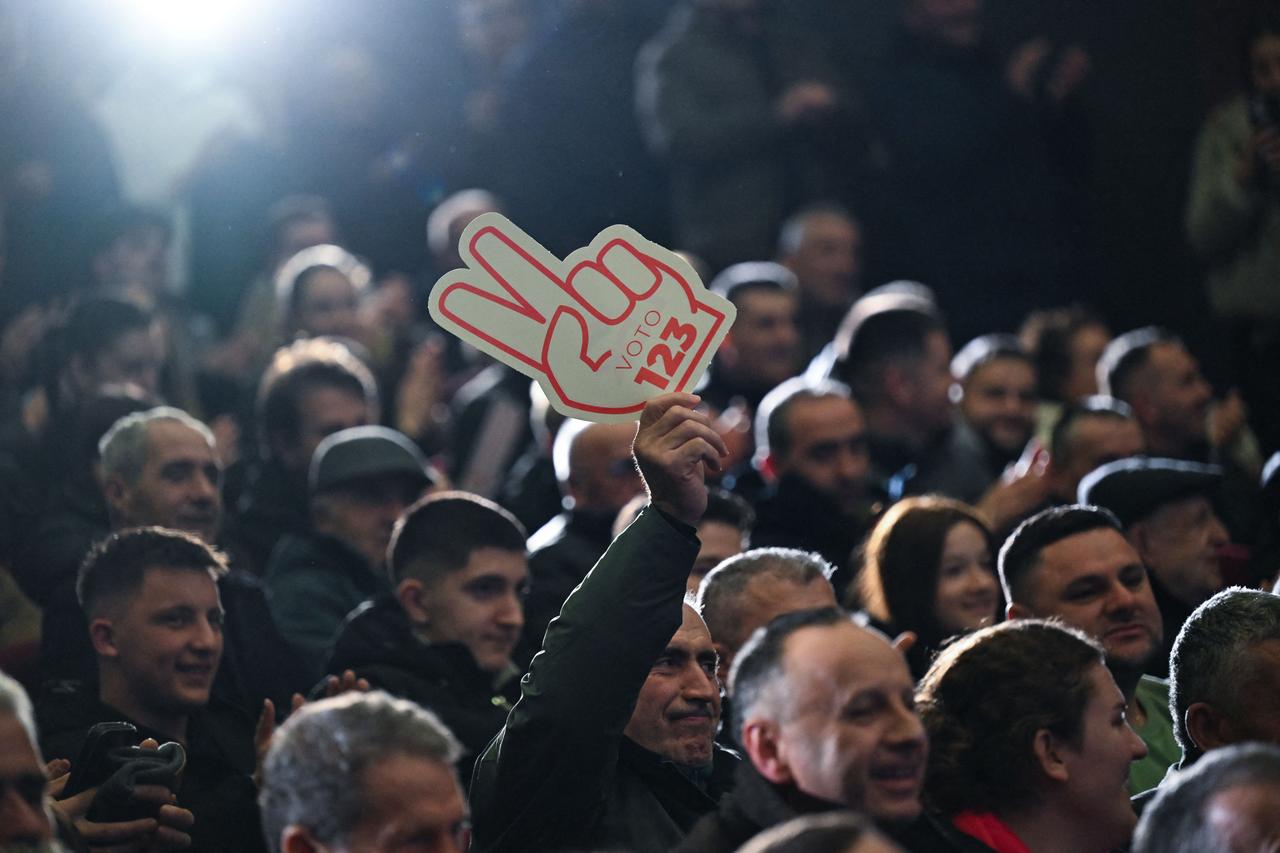 A supporter of the Democratic League of Kosovo (LDK) hold a sign reading "Vote 123" during an election campaign rally in Shtime on Dec. 25, 2025. (AFP Photo)