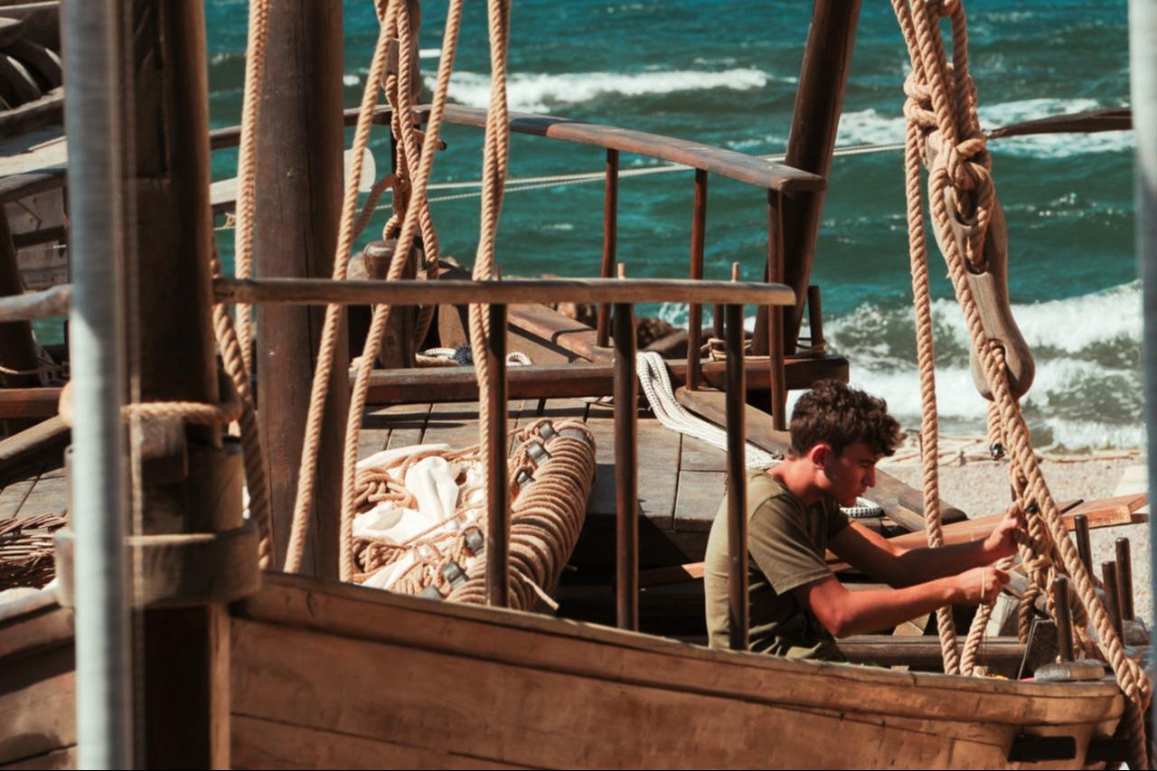 A craftsman prepares rigging on the Hippoi vessel by the Aegean Sea ahead of its maiden voyage, Izmir, Türkiye, Aug. 27, 2025. (Photo via Linkedin/360 Degree Historical Research Association)