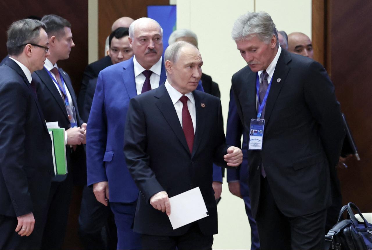 Russia's President Vladimir Putin interacts with Kremlin spokesman Dmitry Peskov during a meeting of the Collective Security Treaty Organisation (CSTO) Heads of State Council at the Yntymak Ordo (Palace of Unity) presidential residence in Bishkek on November 27, 2025. (AFP Photo)