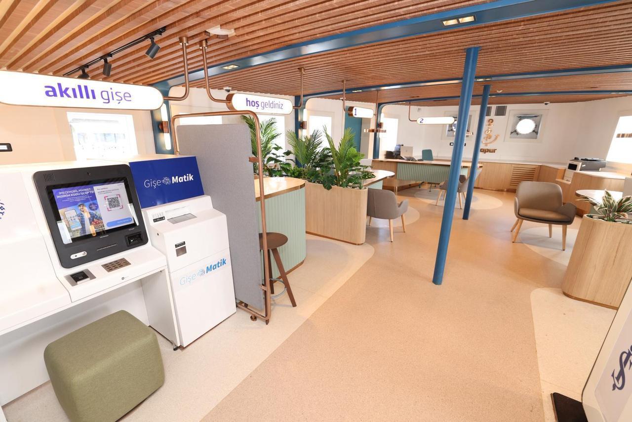 Interior of Isbank’s "Is Vapur (Is Ferry)," featuring smart kiosks, customer service areas, and coworking spaces designed for public use in Istanbul, Türkiye. (AA Photo)