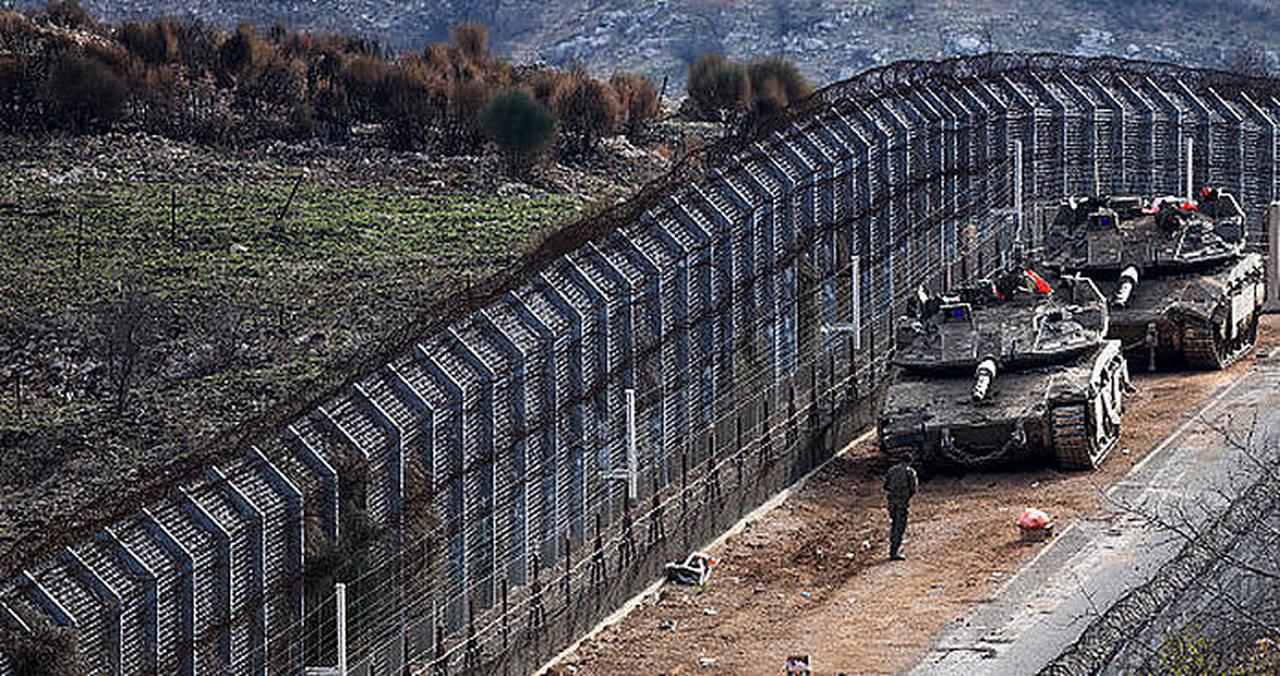 Israeli military vehicles are stationed close to the Druze village of Majdal Shams, by the fence separating the Israel-annexed Golan heights and a buffer zone with the rest of the Syrian territory on Dec. 10, 2024. (AFP Photo)