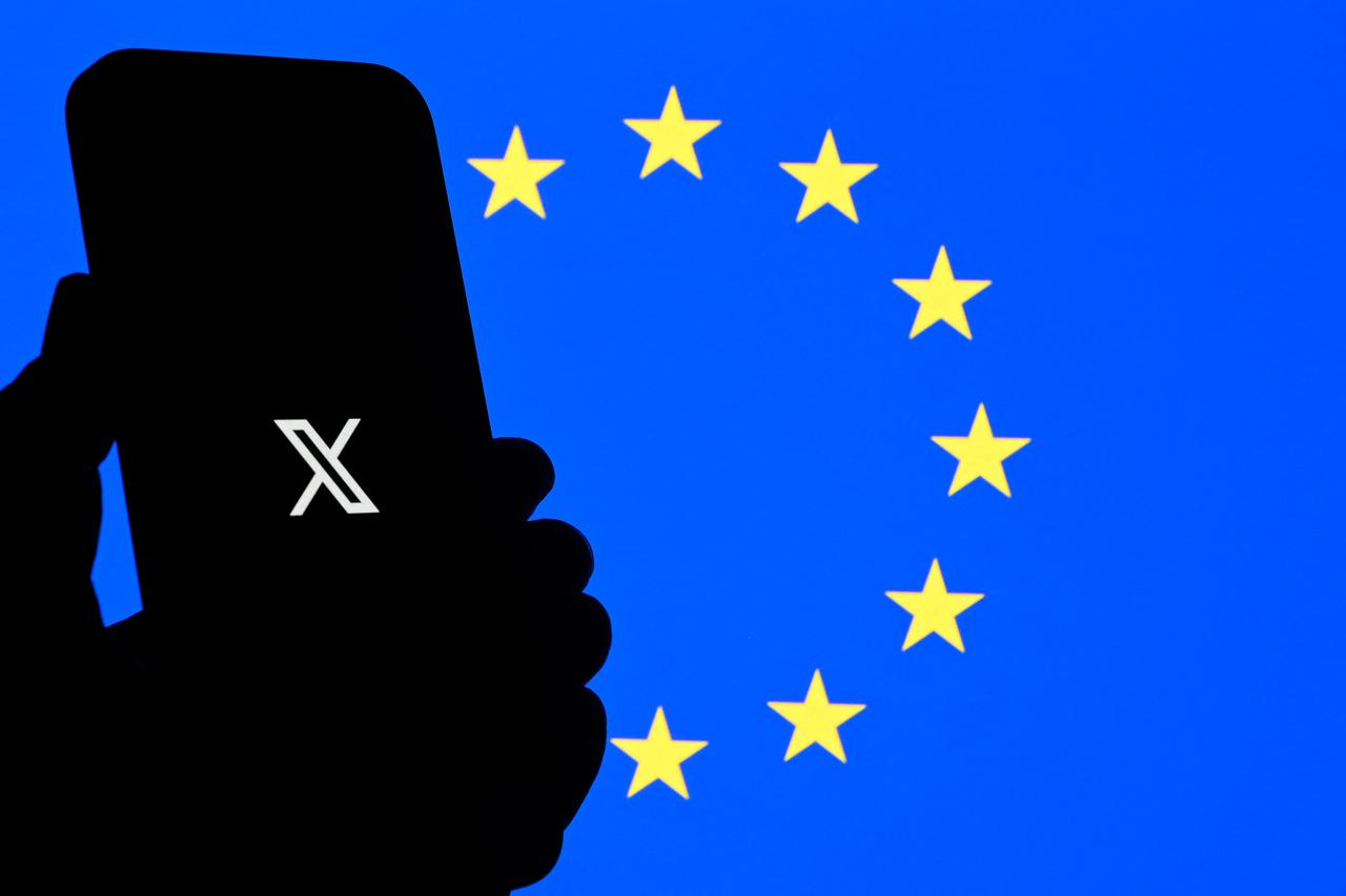 This illustration photograph shows the logo of X (formerly Twitter) social network displayed on a smartphone in front a Euopean Union flag in Brussels, Belgium on Sept. 29, 2025. (AFP File Photo)