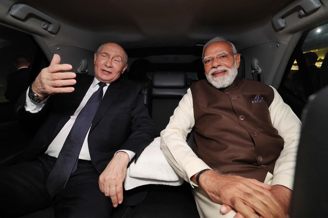 India's Prime Minister Narendra Modi (R) and Russia's President Vladimir Putin sit in a car as they depart Palam Air Force Base after the latter's arrival in New Delhi, December 4, 2025. (AFP Photo)