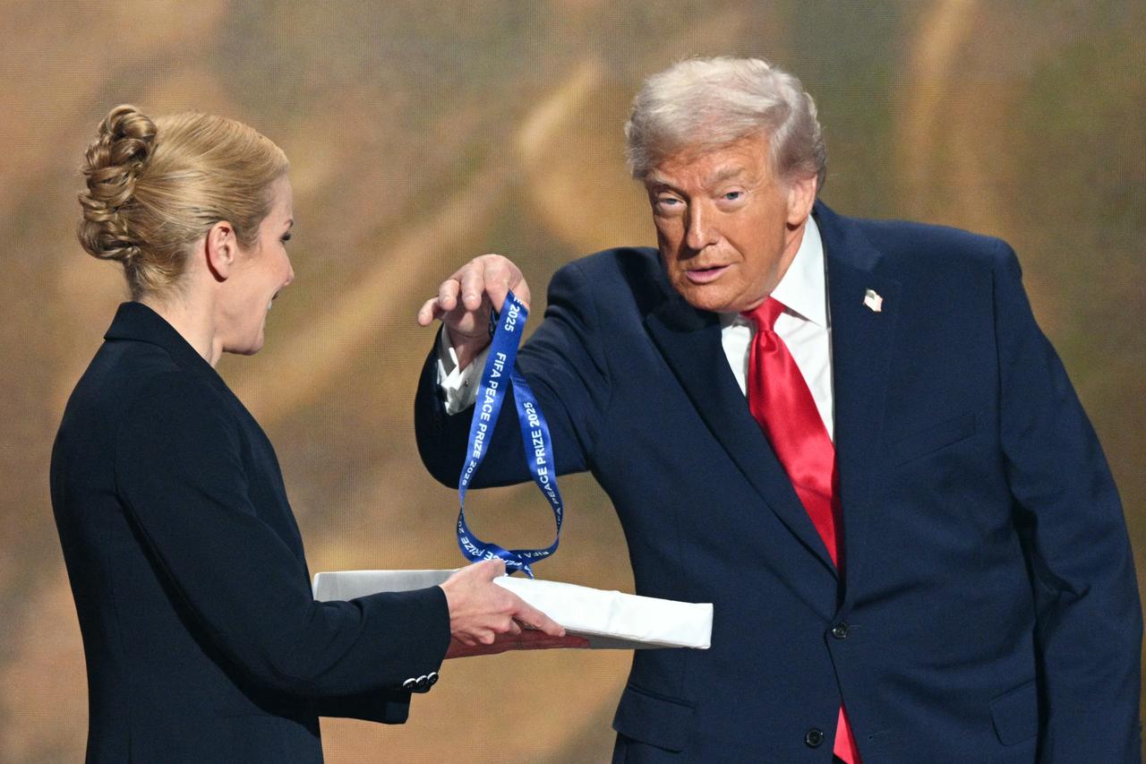 (L-R) US President Donald Trump holds a medal as he receives the FIFA Peace Prize from Italian Fifa President Gianni Infantino (out of frame) during the draw for the 2026 FIFA Football World Cup taking place in the US, Canada and Mexico, at the Kennedy Center, in Washington, DC, on Dec. 5, 2025. (AFP Photo)