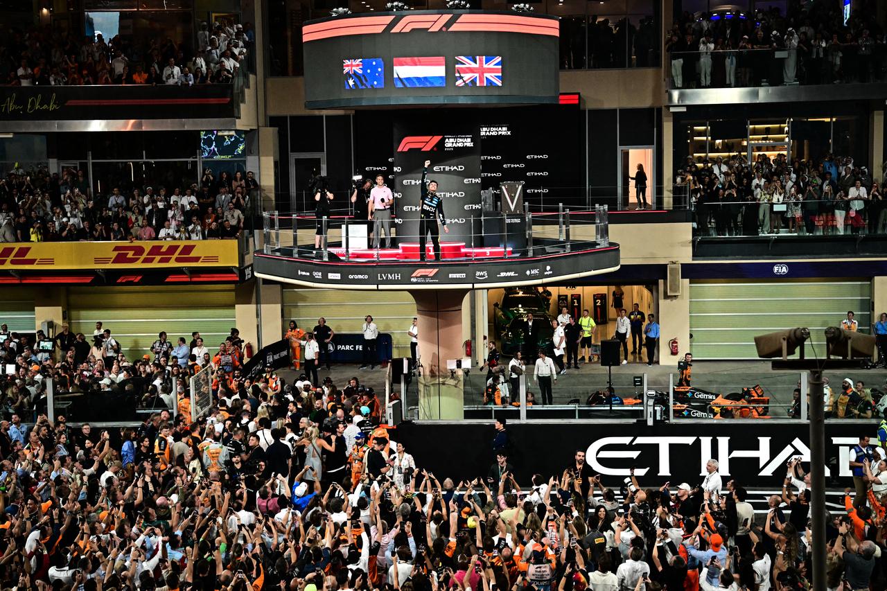 World champion and race third-placed McLaren's British driver Lando Norris celebrates on the podium at the end of the Abu Dhabi Formula One Grand Prix at the Yas Marina Circuit in Abu Dhabi on Dec. 7, 2025. (AFP Photo)