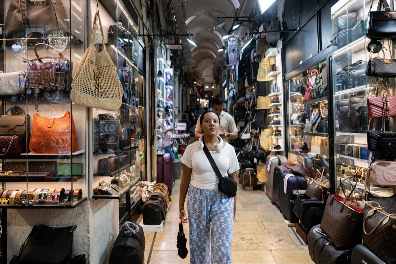 Visitors stroll past shops in the historic Grand Bazaar, Istanbul, Türkiye, on July 9, 2024. (AFP Photo)