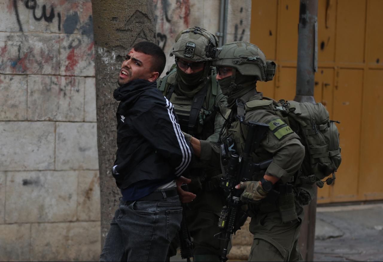 Israeli soldiers detain a young Palestinian man during a raid on the Old City in Hebron, West Bank, Dec. 6, 2025. (AA Photo)