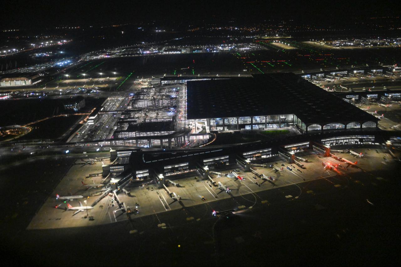 An aerial view of Istanbul Airport, illuminated by glowing lights in the darkness in Istanbul, Türkiye, November 17, 2025. (AA Photo)