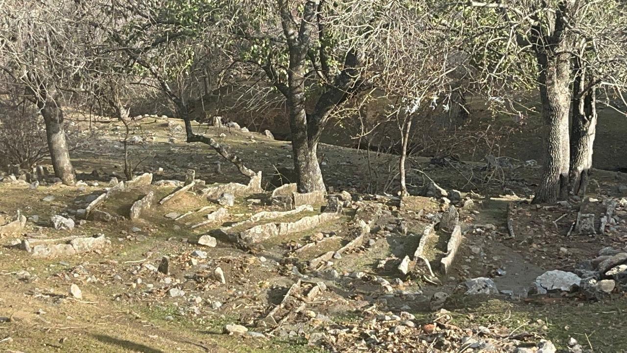 Long stone-lined graves spread across the slope near the underground mosque on Gomek Plateau in Batman’s Sason district, Türkiye, Dec. 6, 2025. (IHA Photo)