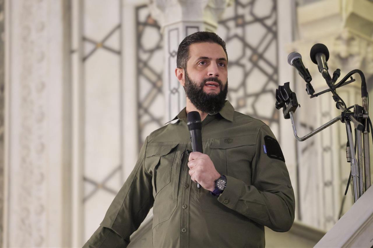 What does Sharaa’s wearing of military uniform on Syrian Liberation Day signify?