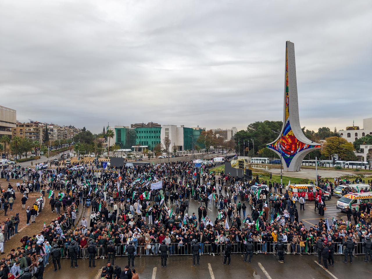 Hundreds of people gather in Umayyad Square waving Syrian flags and celebrating the first anniversary of the fall of the 61-year Baath regime in Damascus, Syria on Dec. 8, 2025. (AA Photo)