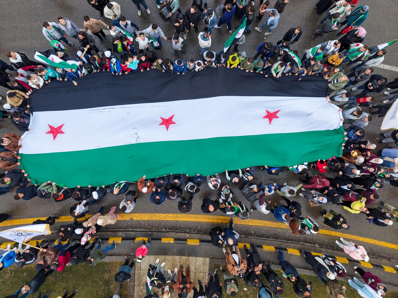 Hundreds of people gather in Umayyad Square waving Syrian flags and celebrating the first anniversary of the fall of the 61-year Baath regime in Damascus, Syria on Dec. 8, 2025. (AA Photo)