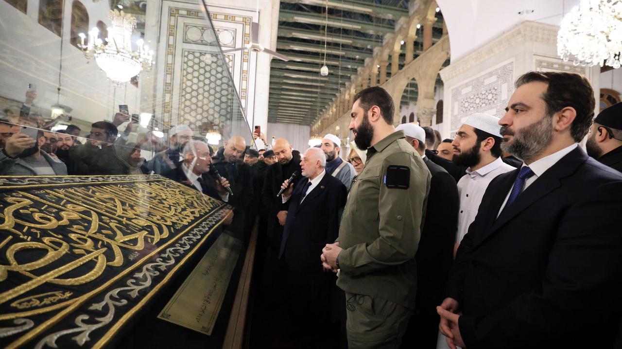 Syrian President Ahmad al-Sharaa wearing military uniform unveils a gift from Saudi Arabia to the Umayyad Mosque after performing the dawn prayer on the first anniversary of the fall of Bashar al-Assad’s regime in Damascus, Syria on Dec. 08, 2025. (AA Photo)