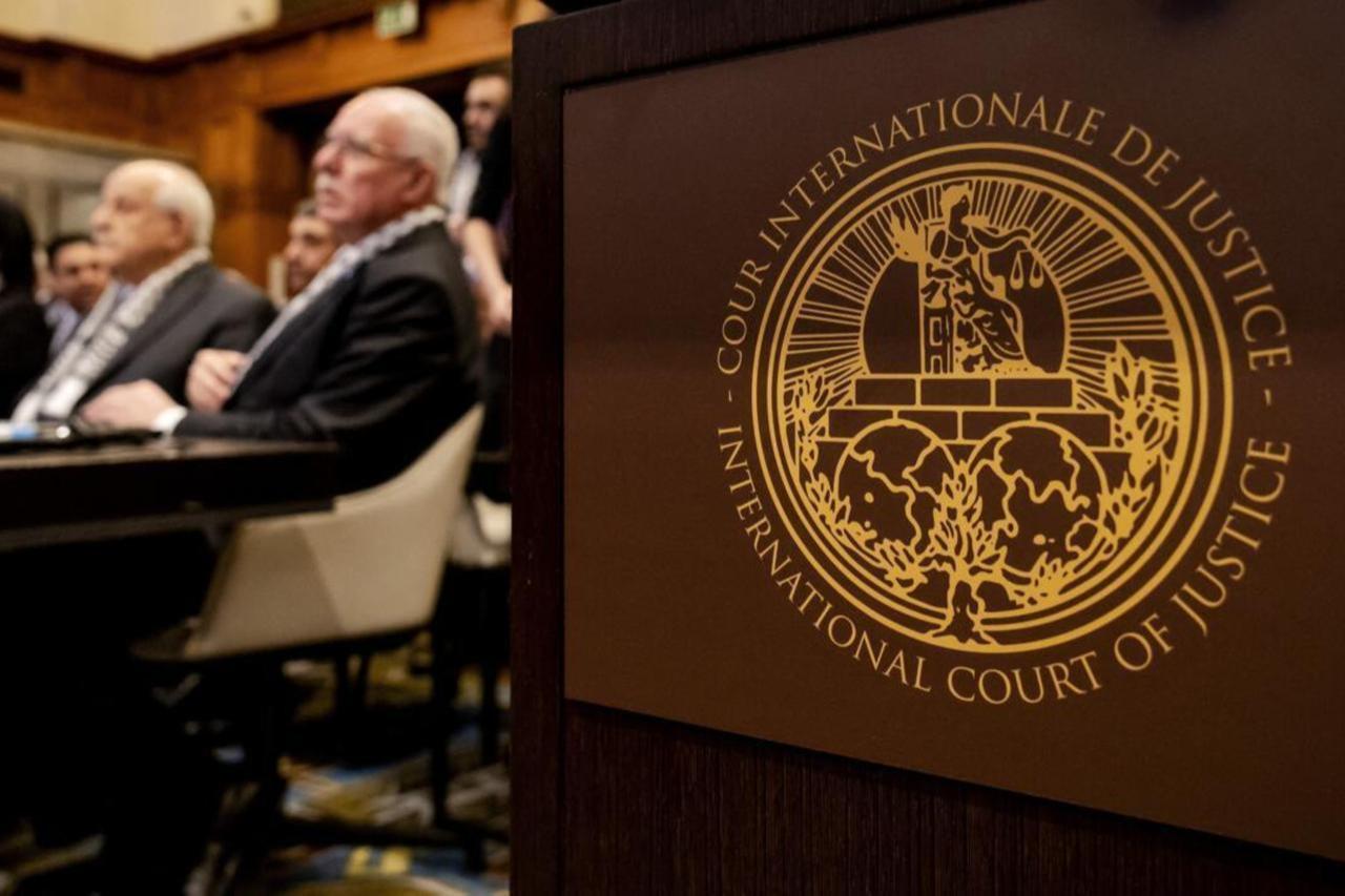 The Logo of the International Court of Justice (ICJ) is seen next to Minister of Foreign Affairs of the Palestinian Authority Riyad al-Maliki (R) and members of his delegation as they listen at the start of a hearing at the ICJ on the legal consequences of the Israeli occupation of Palestinian territories, in The Hague, Netherlands, Feb. 19, 2024 (AFP Photo)