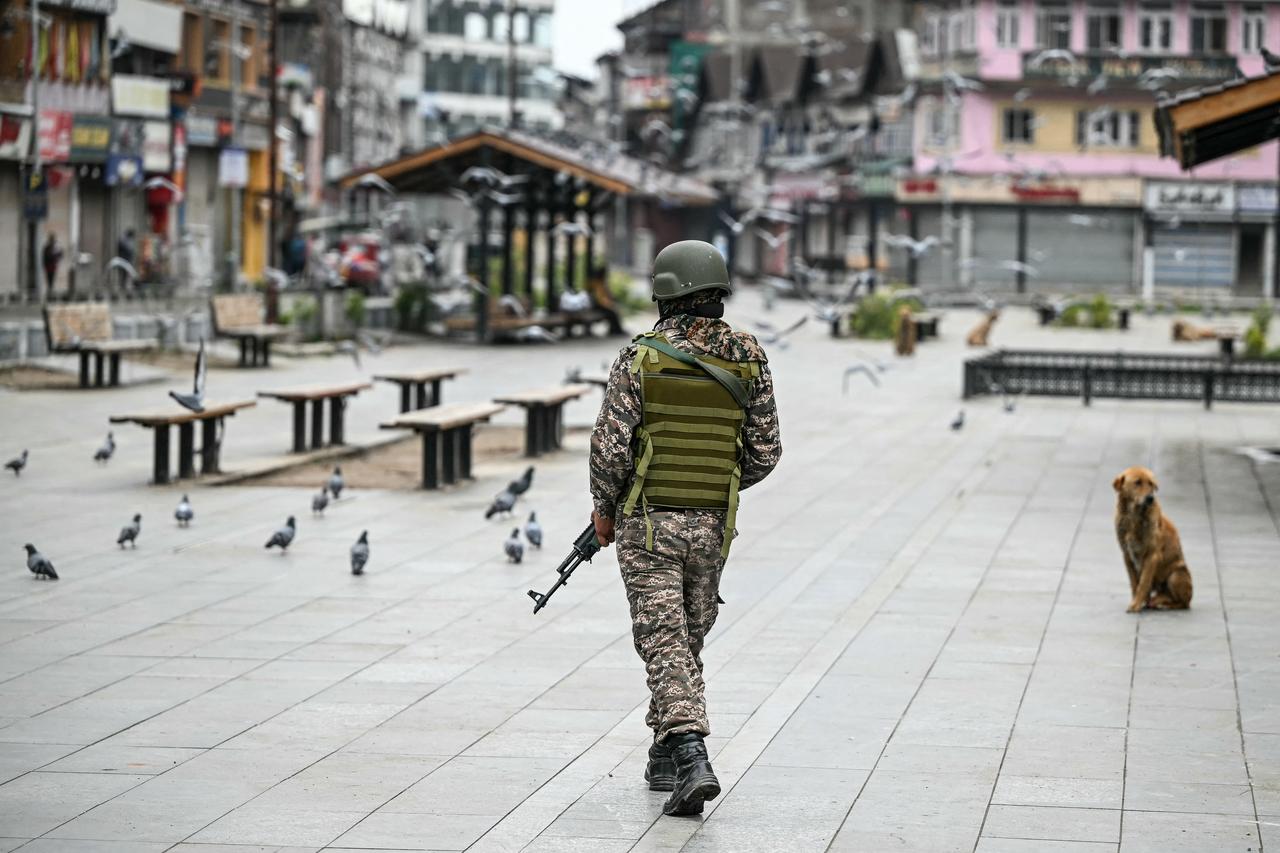 Indian army personnel stand next to explosives, carried by a drone, after it was intercepted by the Indian air defence system, on the outskirts of Amritsar, on May 10, 2025. The Indian army on May 10 reported fresh Pakistani attacks along the border with its arch-foe as the conflict between the nuclear-armed neighbours spiralled. (Photo by Narinder NANU / AFP)